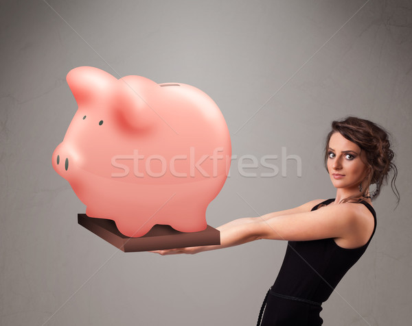 Jovem enorme poupança piggy bank belo Foto stock © ra2studio