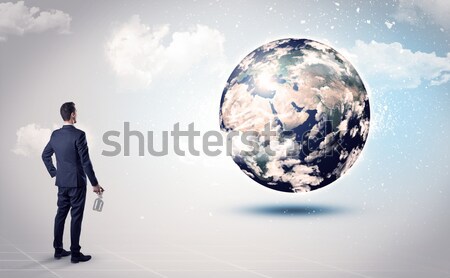 Businessman on rock mountain with a globe Stock photo © ra2studio