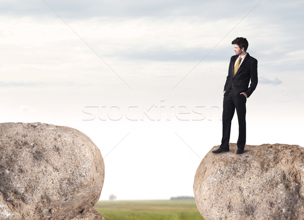 Businessman on rock mountain Stock photo © ra2studio