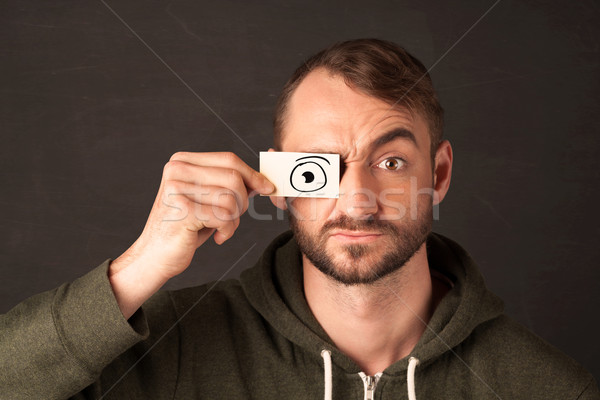 Funny man looking with hand drawn paper eyes Stock photo © ra2studio