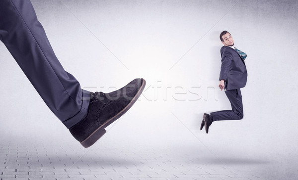 Jeunes travailleur sur grand pied faible [[stock_photo]] © ra2studio