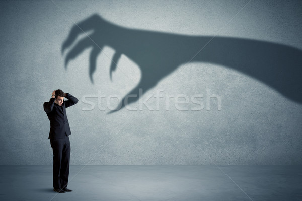 [[stock_photo]]: Homme · d'affaires · grand · monstre · griffe · ombre