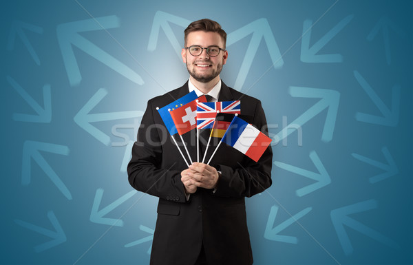 Cheerful boy standing with flag and arrows around Stock photo © ra2studio
