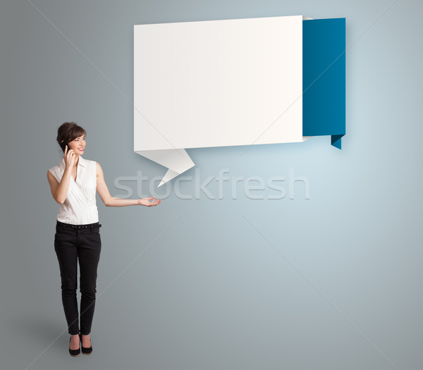 pretty young woman making phone call and presenting modern origami copy space Stock photo © ra2studio