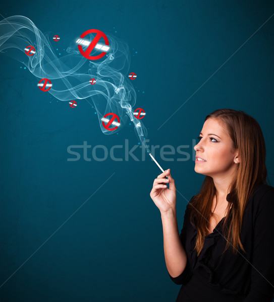 Young woman smoking dangerous cigarette with no smoking signs Stock photo © ra2studio