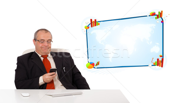 businessman sitting at desk and holding a mobilephone, isolated on white Stock photo © ra2studio