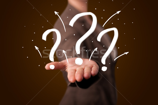 Stock photo: Young woman presenting hand drawn question marks