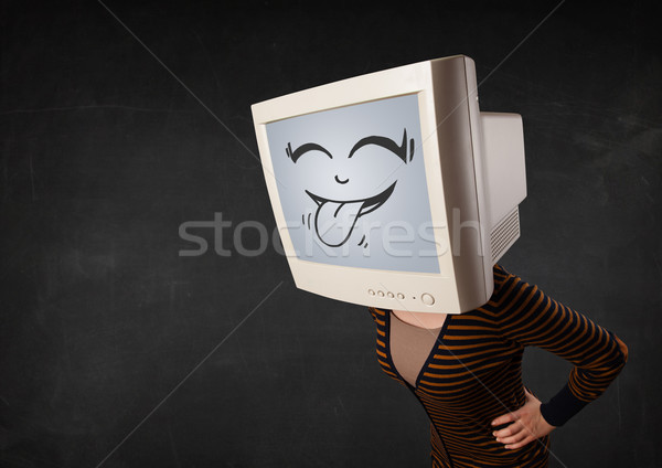 Young girl wearing a monitor with a funny face Stock photo © ra2studio