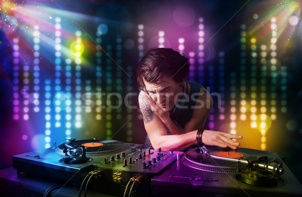 Dj playing songs in a disco with light show Stock photo © ra2studio