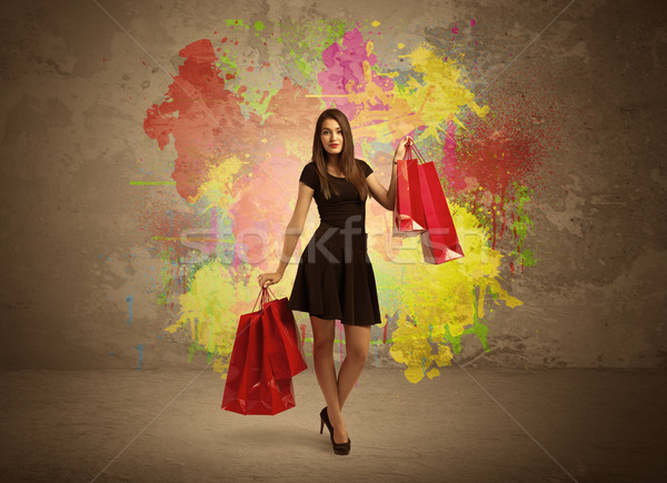 Girl with shopping bags and paint splatter Stock photo © ra2studio
