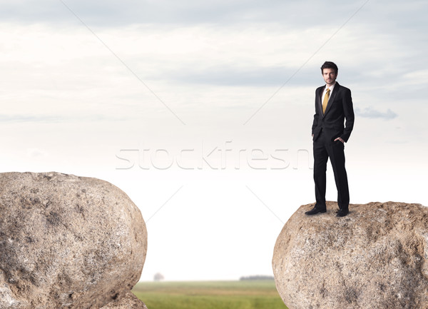 Businessman on rock mountain Stock photo © ra2studio