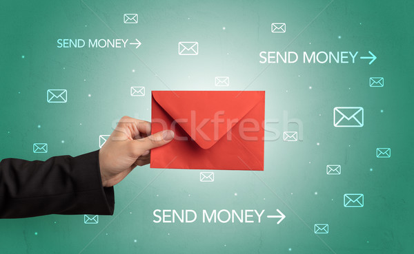 Hand holding envelope with symbols around Stock photo © ra2studio