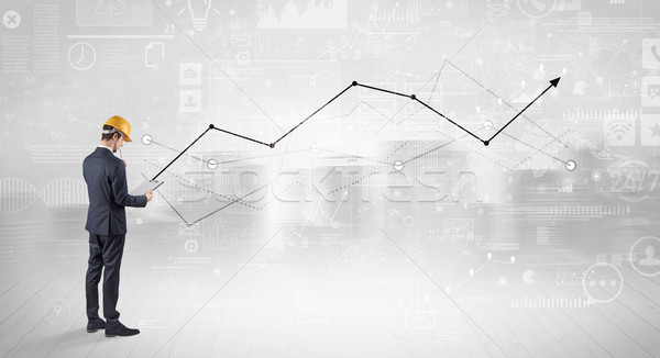 Engineer holding a plan and standing with graphs, charts and reports on the background Stock photo © ra2studio