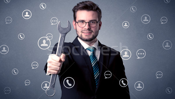 Handsome man standing with tool on his hand Stock photo © ra2studio