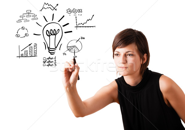 Young business woman drawing light bulb with various diagrams on whiteboard isolated on white Stock photo © ra2studio