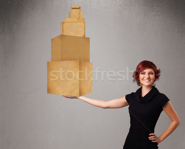 Young lady holding a set of brown cardboard boxes Stock photo © ra2studio
