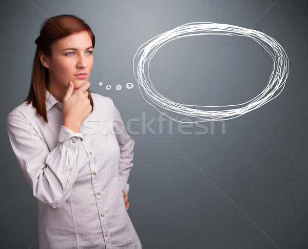 Young lady thinking about speech or thought bubble with copy spa Stock photo © ra2studio