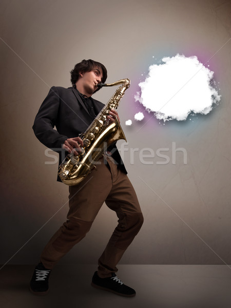 Young man playing on saxophone with copy space in white cloud Stock photo © ra2studio