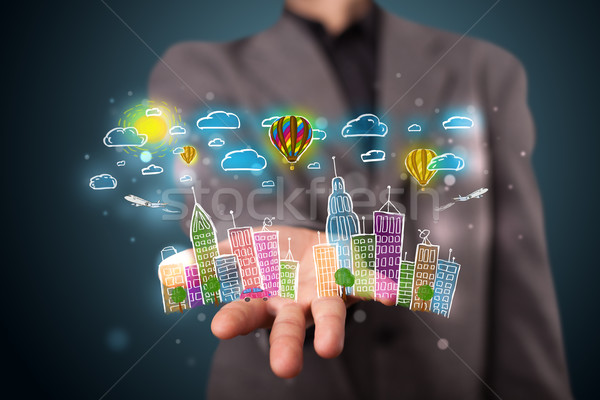 Stock photo: Young businessman presenting colorful hand drawn metropolitan ci