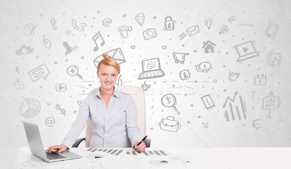 Business woman sitting at table with hand drawn media icons  Stock photo © ra2studio