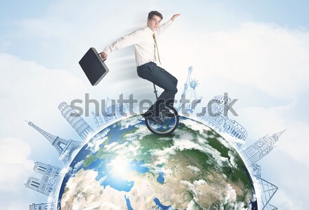 Man riding unicycle around the globe with major cities Stock photo © ra2studio