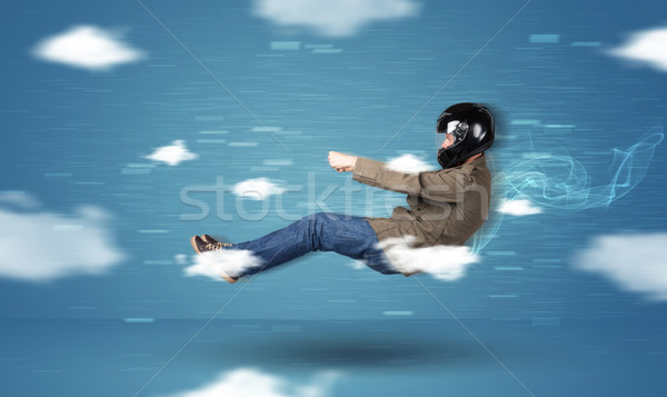 Funny racedriver young man driving between clouds concept Stock photo © ra2studio