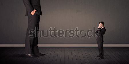 Little bussinesman in front of a giant boss legs concept Stock photo © ra2studio