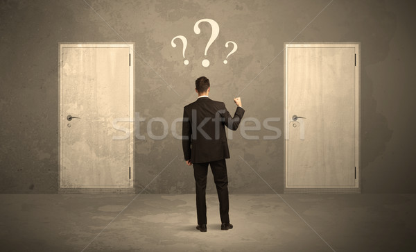 Businessman standing in front of doors Stock photo © ra2studio