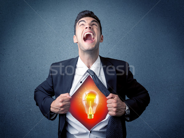 Businessman ripping off shirt and idea light bulb appears  Stock photo © ra2studio