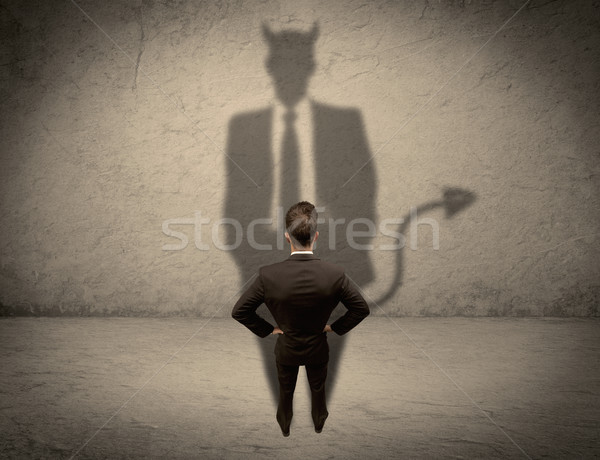 Salesman facing his own devil shadow Stock photo © ra2studio