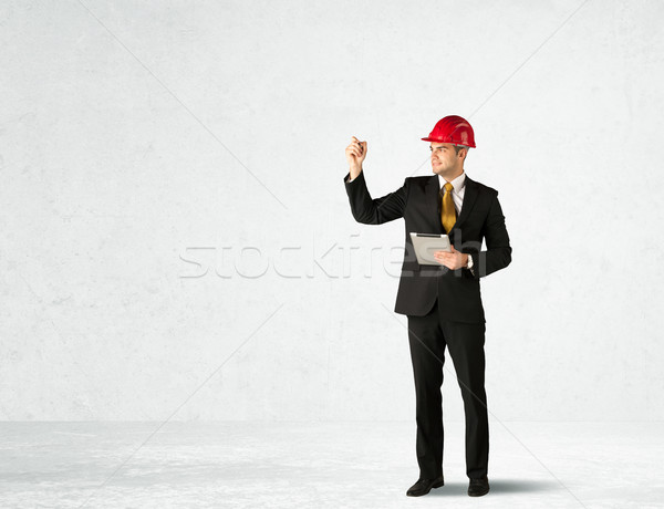 Young architect drawing in empty space Stock photo © ra2studio