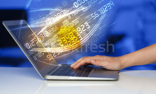 Man typing on modern notebook with number technology data coming Stock photo © ra2studio