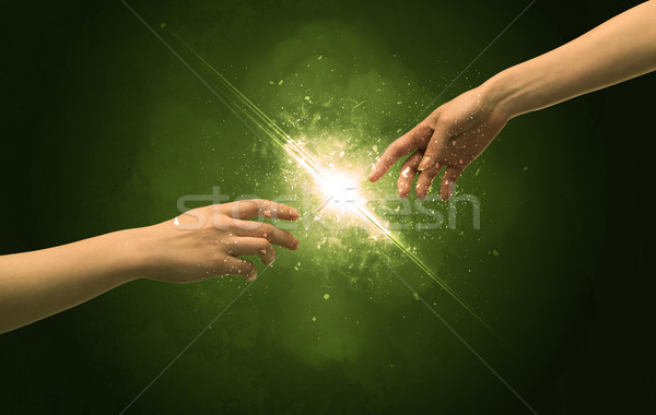 Stock photo: Touching arms lighting spark at fingertip