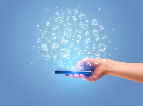 Hand with phone and drawn office icons Stock photo © ra2studio
