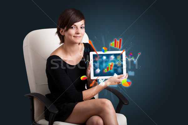 woman holding modern tablet with colorful diagrams and graphs Stock photo © ra2studio