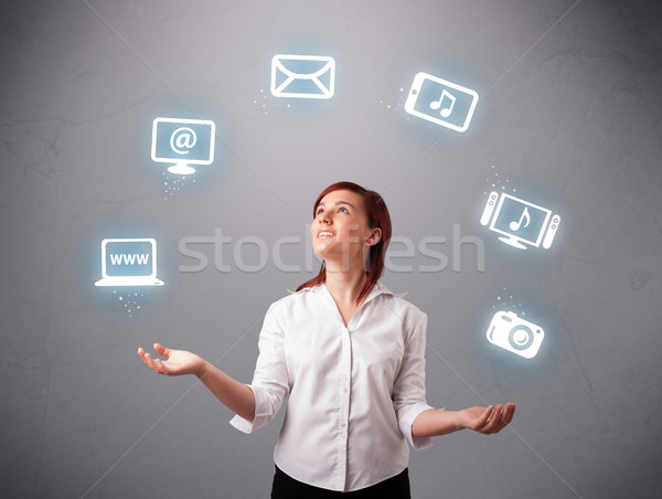 pretty girl juggling with elecrtonic devices icons Stock photo © ra2studio