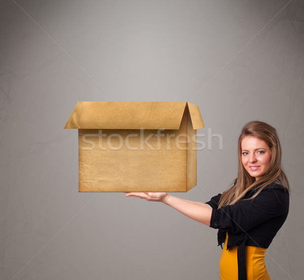 Young woman holding an empty cardboard box Stock photo © ra2studio