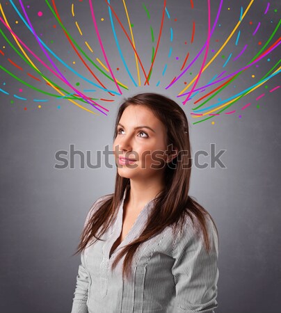 Young girl thinking with colorful abstract lines overhead Stock photo © ra2studio