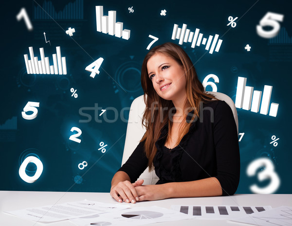 Ziemlich jungen Geschäftsfrau Sitzung Schreibtisch Diagramme Stock foto © ra2studio