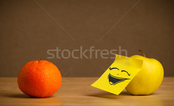 Apple with post-it note laughing on orange Stock photo © ra2studio