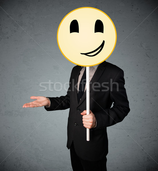 üzletember tart mosolygós arc emotikon citromsárga fej Stock fotó © ra2studio
