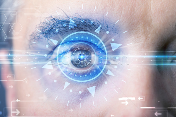 Cyber man with technolgy eye looking into blue iris Stock photo © ra2studio