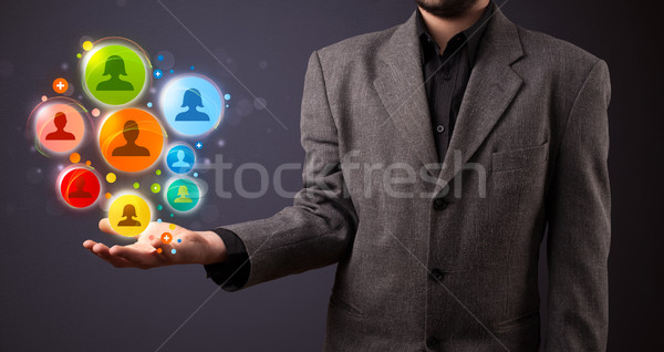 Social network icons in the hand of a businessman Stock photo © ra2studio