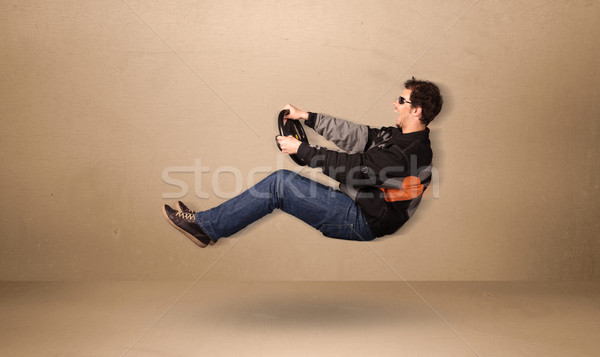 Happy funny man driving a flying car concept Stock photo © ra2studio