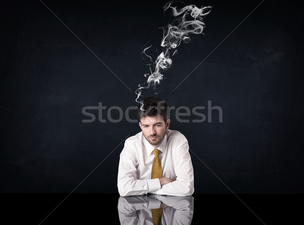 Depressed businessman with smoking head Stock photo © ra2studio