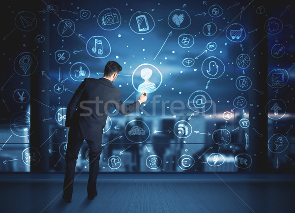 Businessman drawing social media connection scheme Stock photo © ra2studio