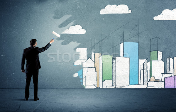 Salesman painting tall buildings on urban wall Stock photo © ra2studio