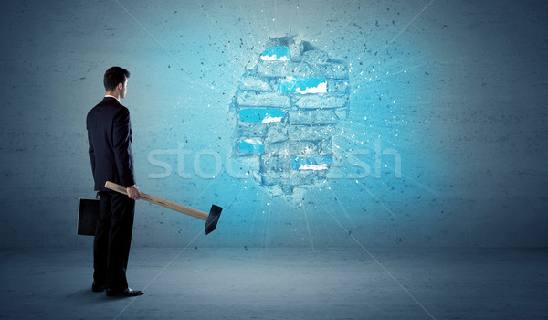 Business man hitting brick wall with huge hammer Stock photo © ra2studio