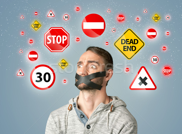 Young man with glued mouth and traffic signals Stock photo © ra2studio