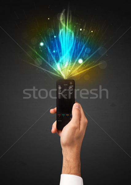 Hand with remote control and explosive signal Stock photo © ra2studio